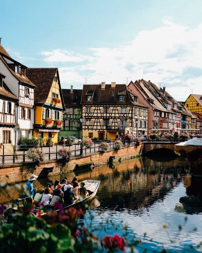 Experience a picturesque canal cruise amid half-timbered houses in Colmar, France.